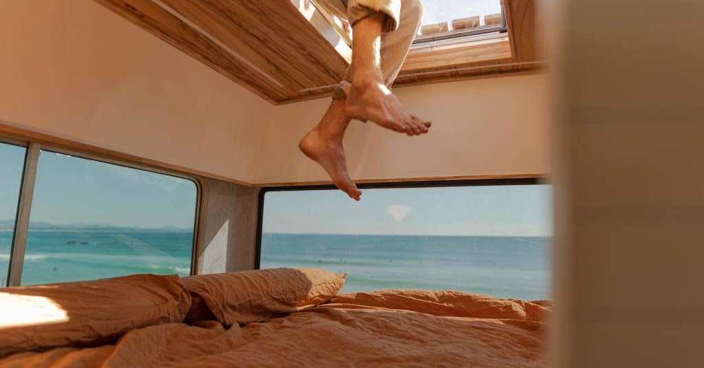 Ocean-view camper bedroom by Byron Bay Van Fitouts